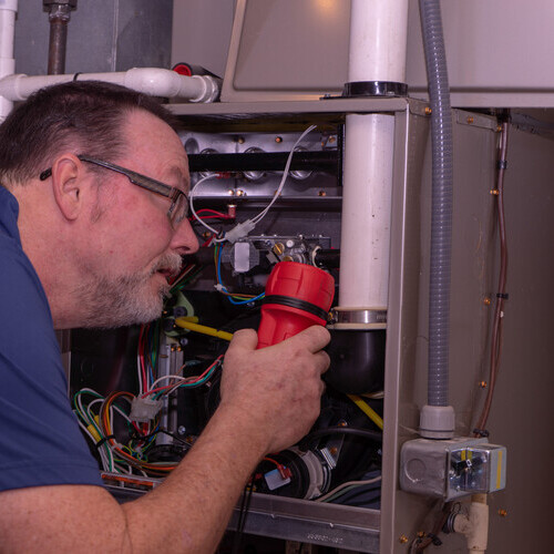 technician checking a furnace