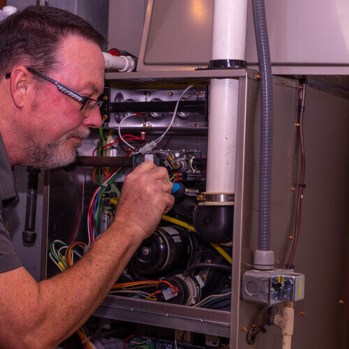 Furnace Tech Taking A Part Off A Gas Furnace