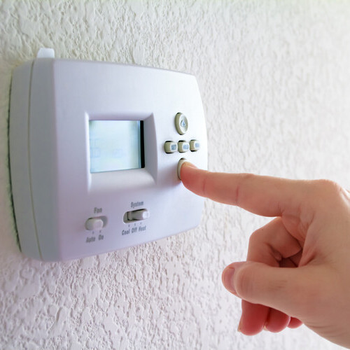 digital thermostat with finger pressing button