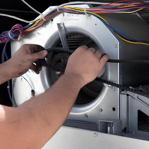 technician replacing an AC blower