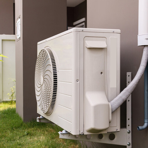 a heat pump along the side of a building